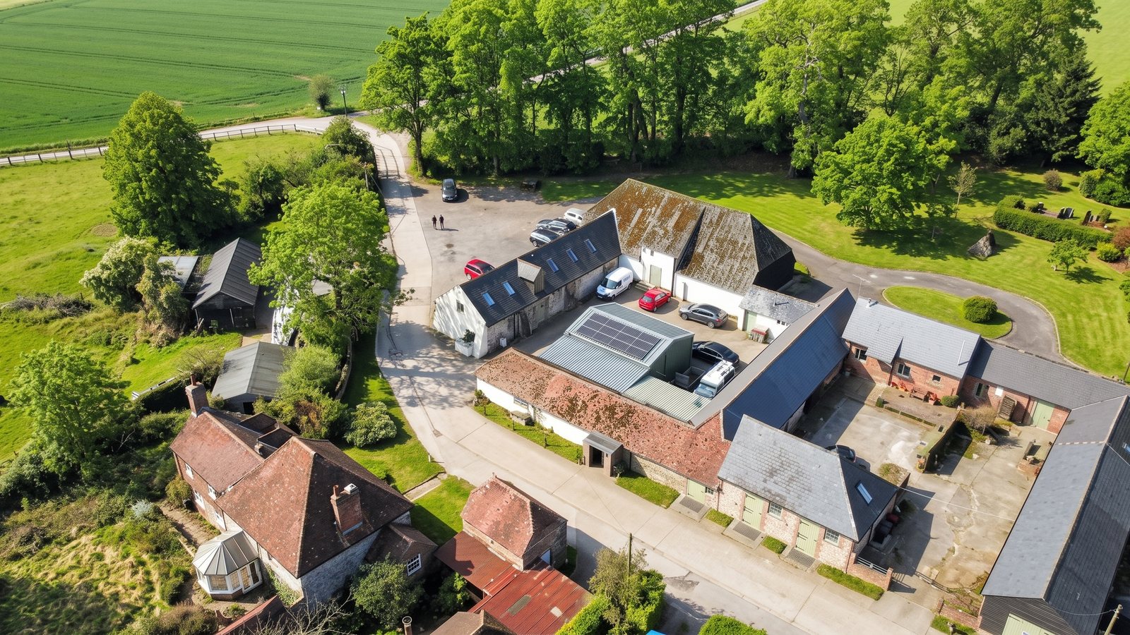 The barn, the office block and the farmland around them, from the air