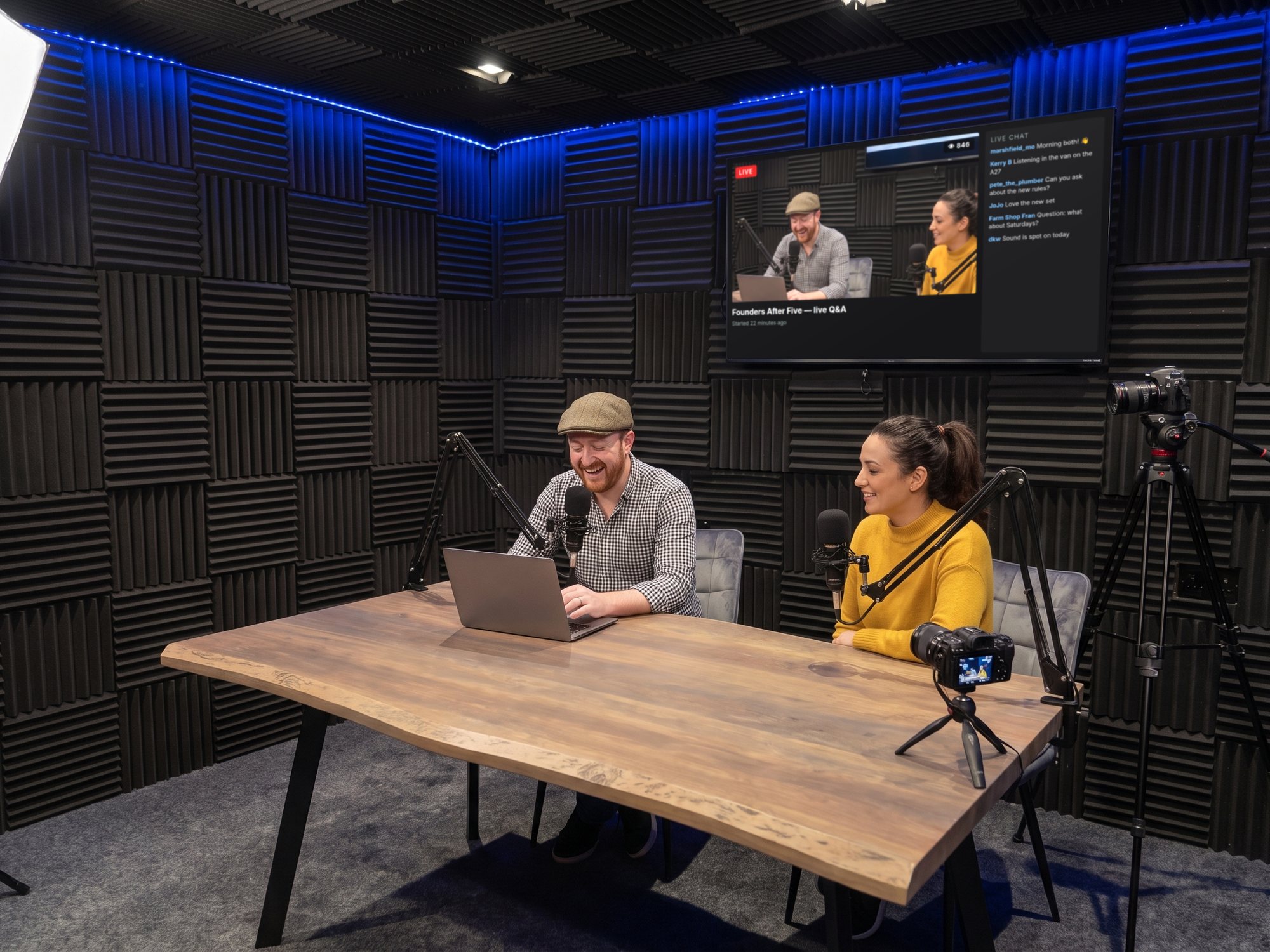 A live-streamed podcast, the stream and viewer chat on the wall screen