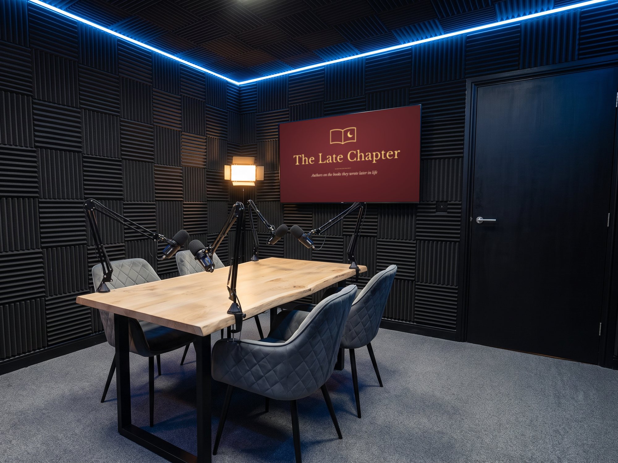 The table set for four under a warm lamp, a book show's title card on the screen