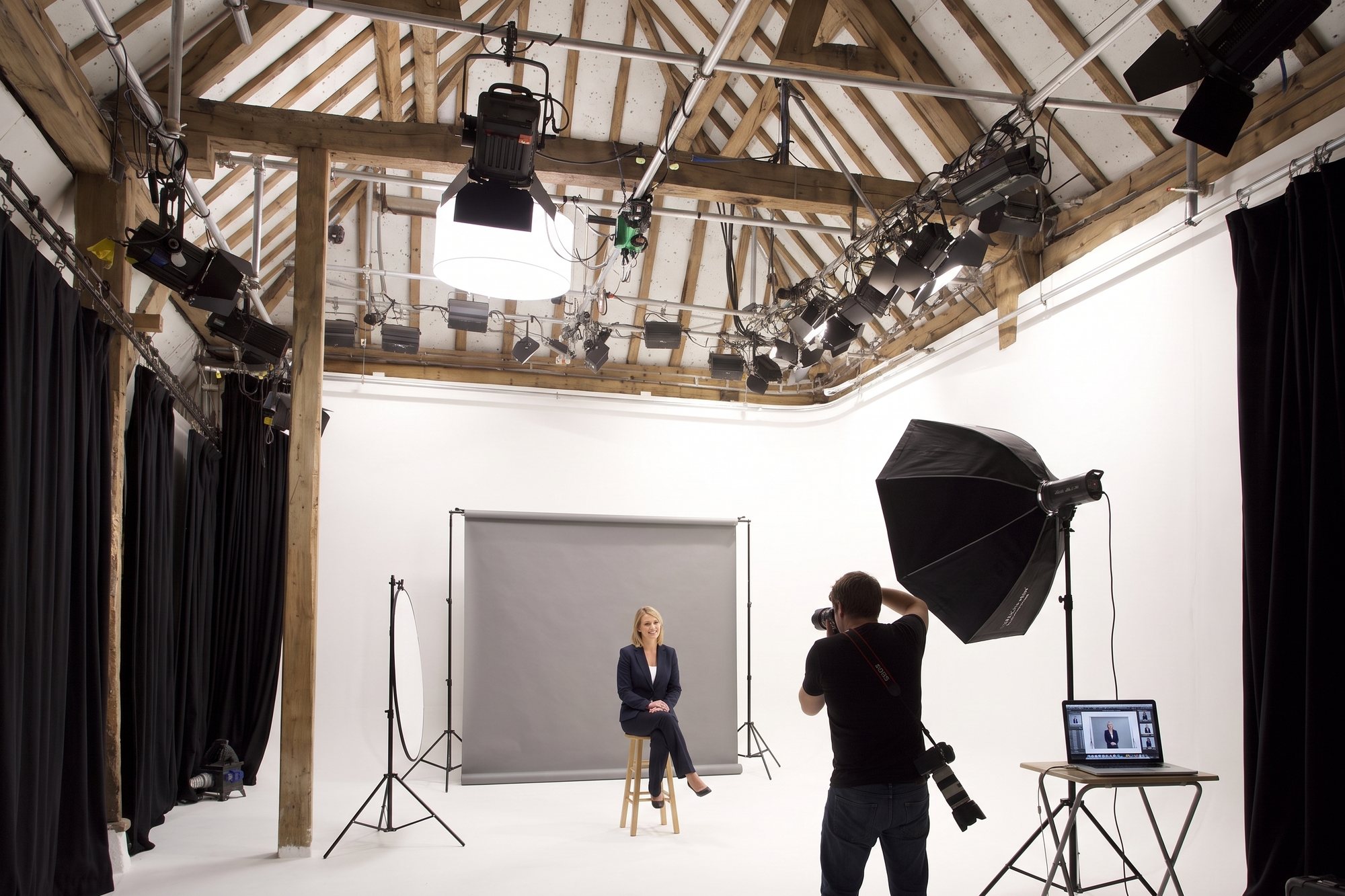 A headshot session on a grey paper backdrop set up on the cove