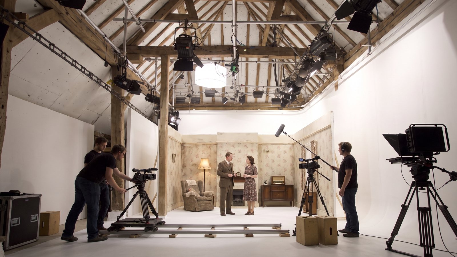 A 1940s sitting-room set built on the cove, actors rehearsing and a camera on track