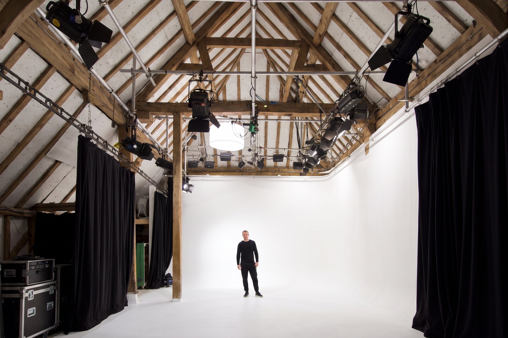 A portrait on the White Space cove under the oak roof and lighting grid