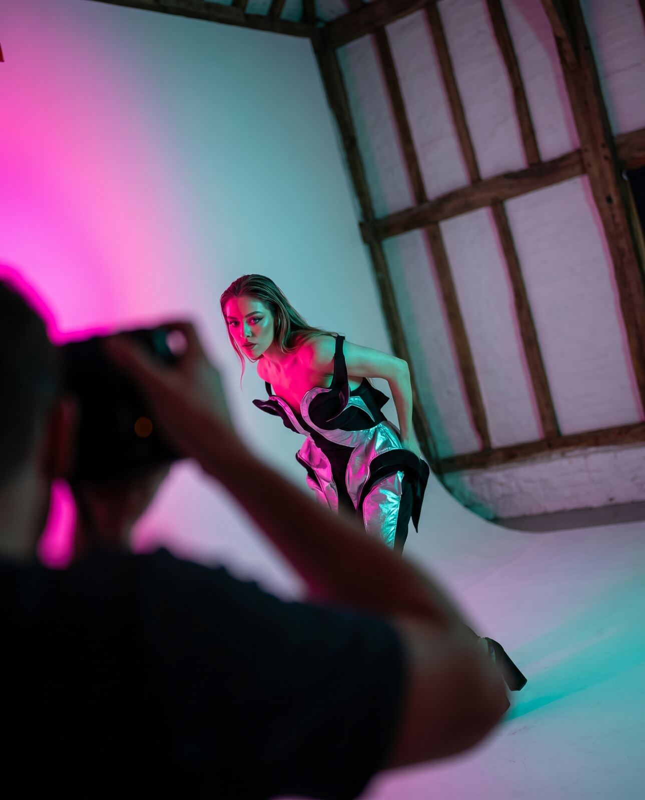 Fashion model shot at a dutch angle under colour gels