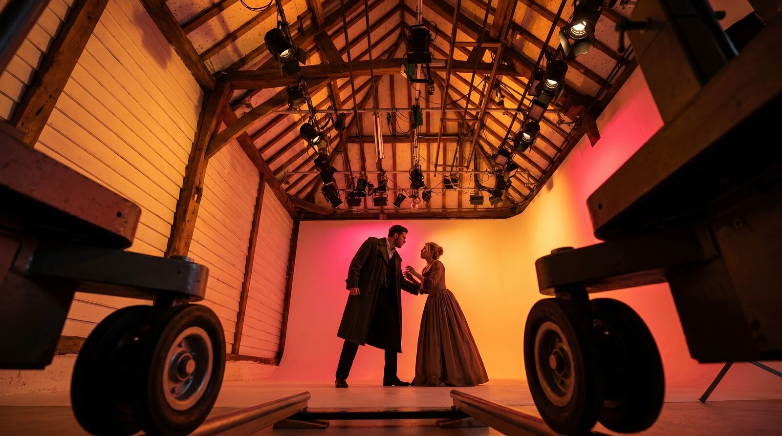 Film drama scene lit in amber inside the barn