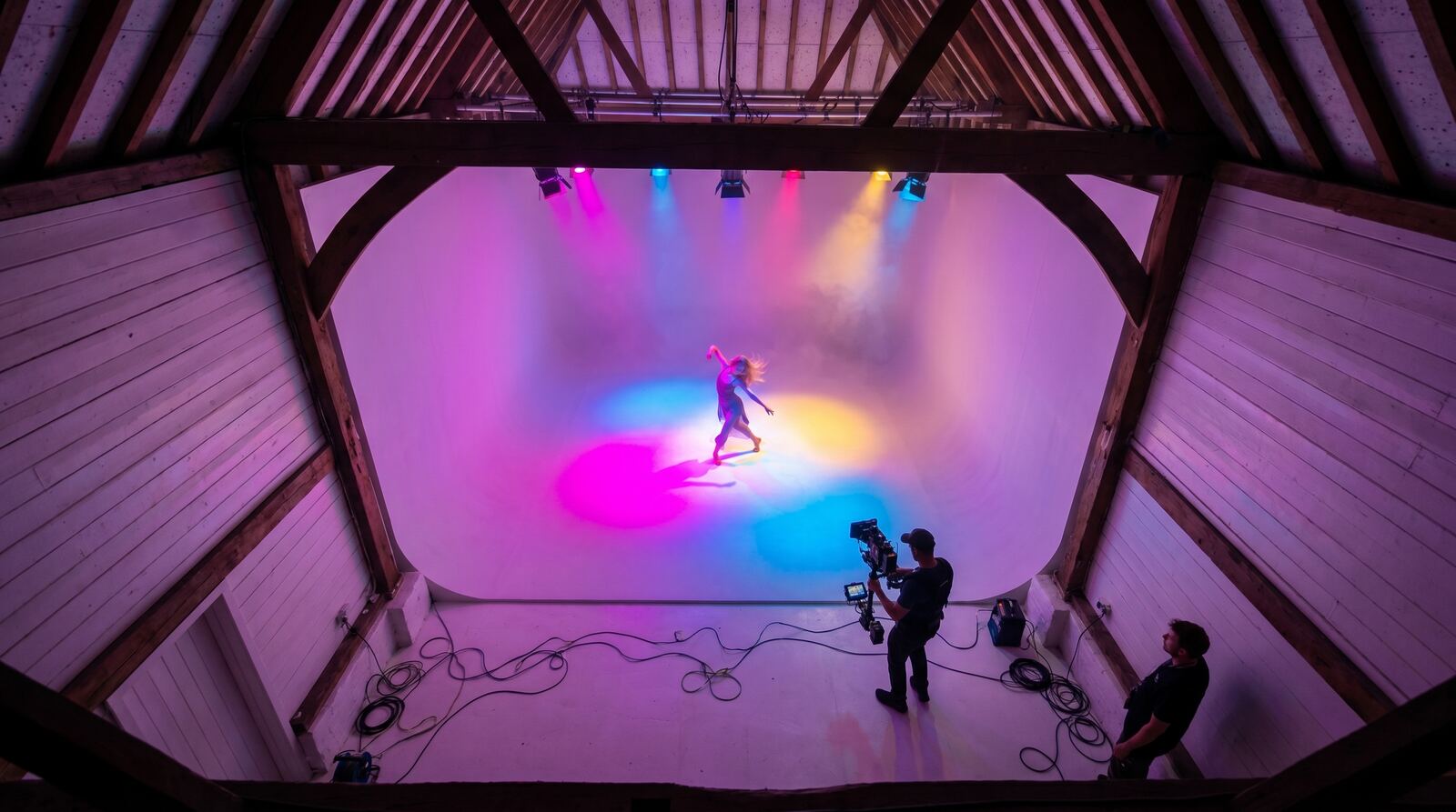 Wide view of the barn studio under a colour gel wash