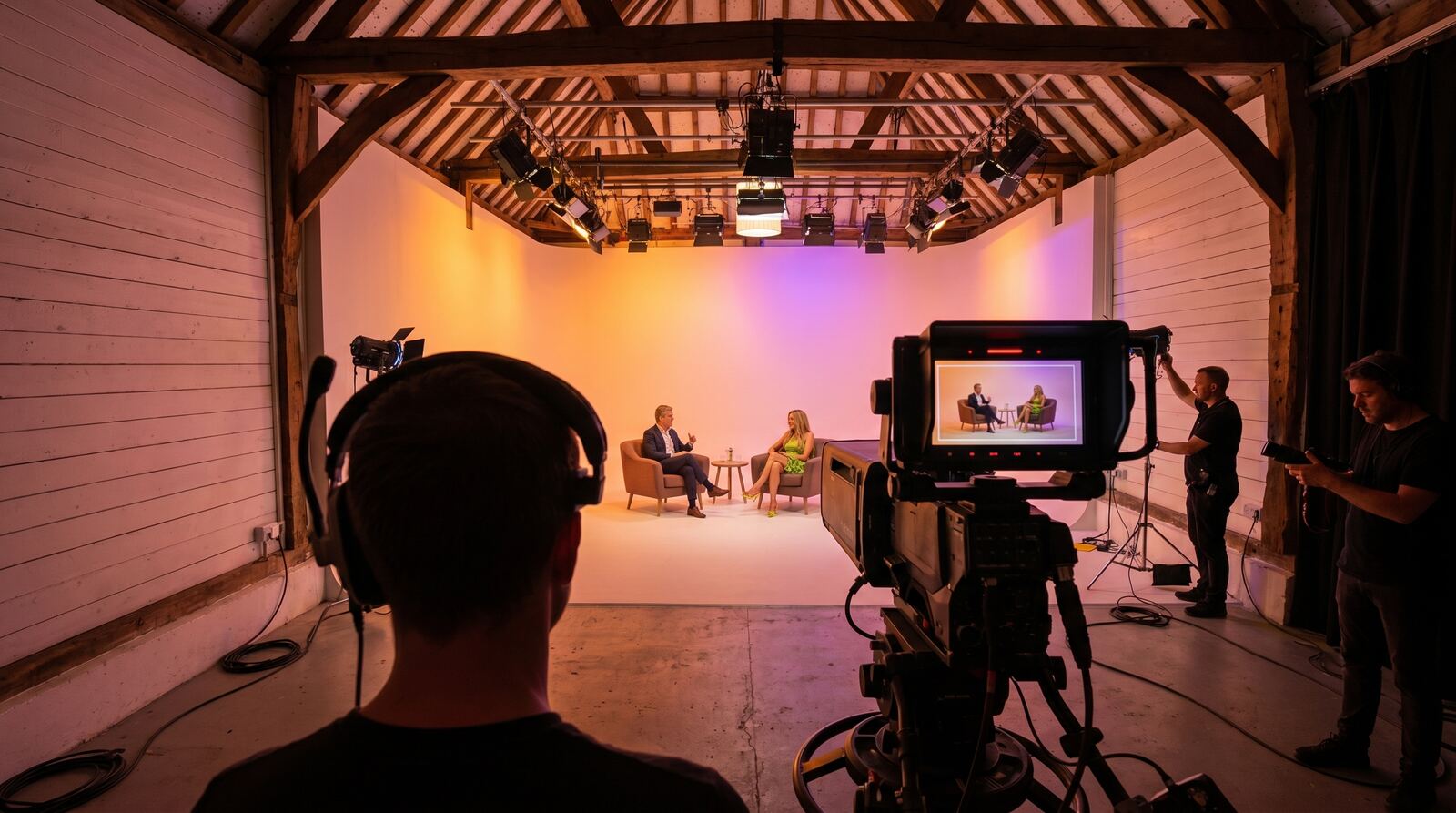 Over-the-shoulder shot of a presenter being filmed