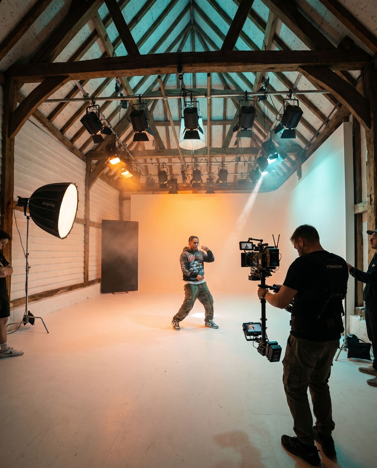 Artist performing under colour gels for a music video