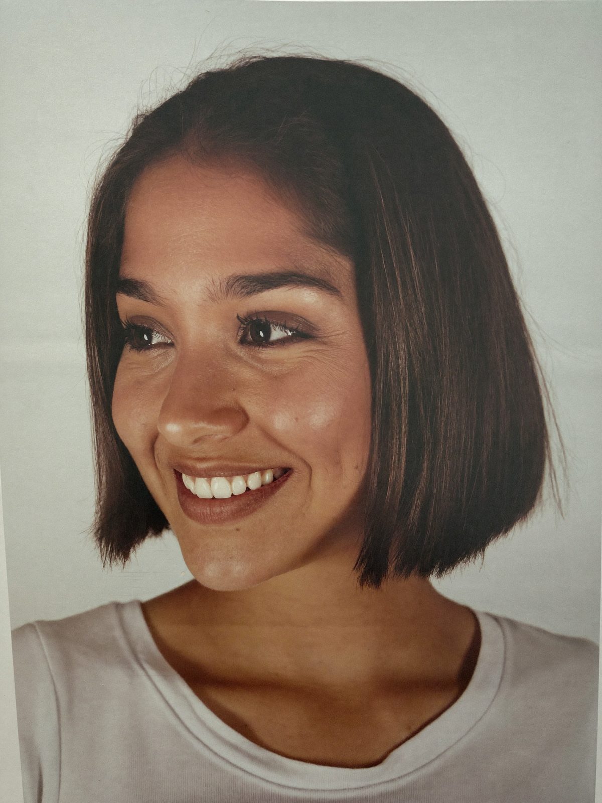 Example actor headshot, a young woman with a dark bob in a white t-shirt