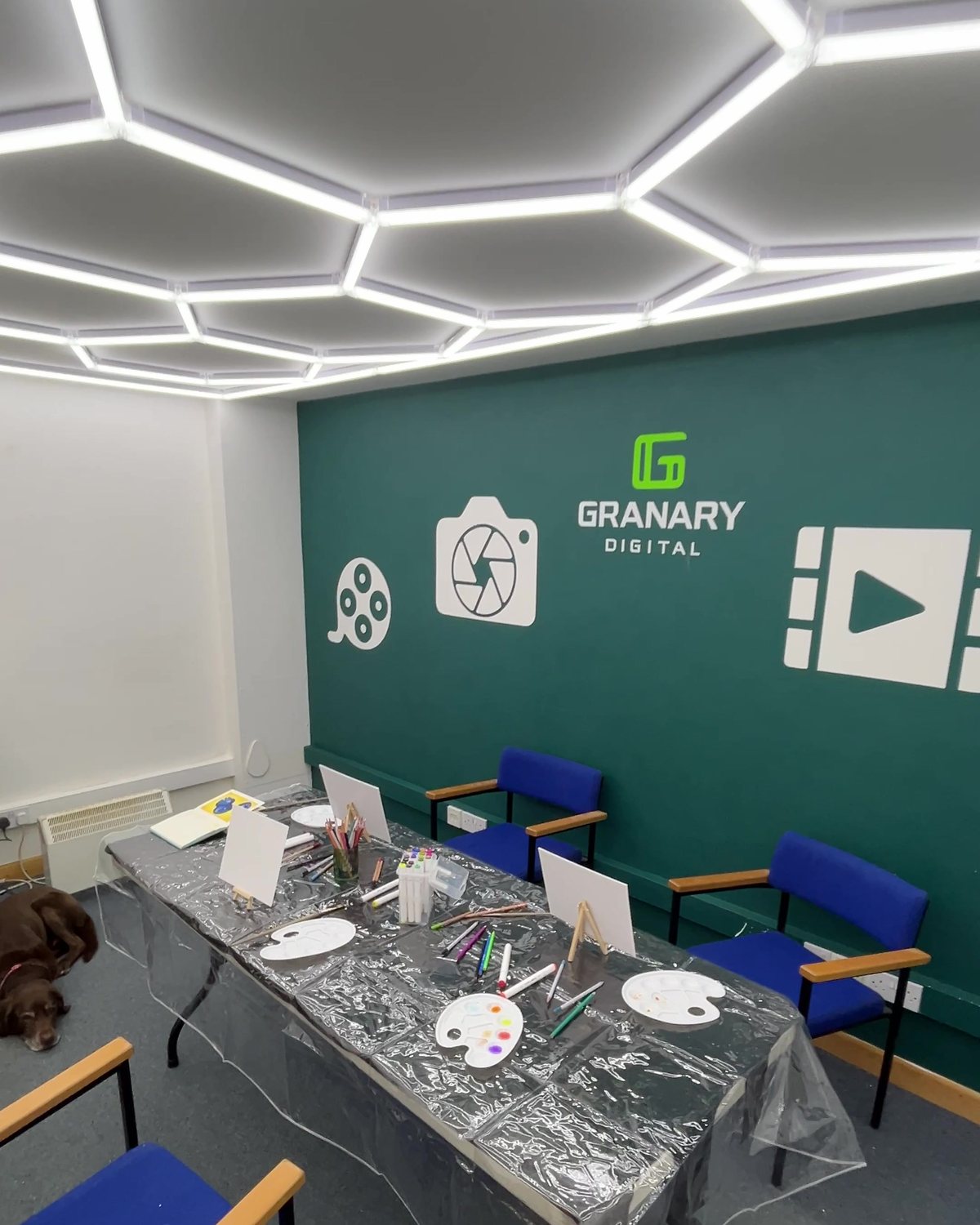 The Grain Hopper set up for a workshop, tables laid out under the hexagonal lighting