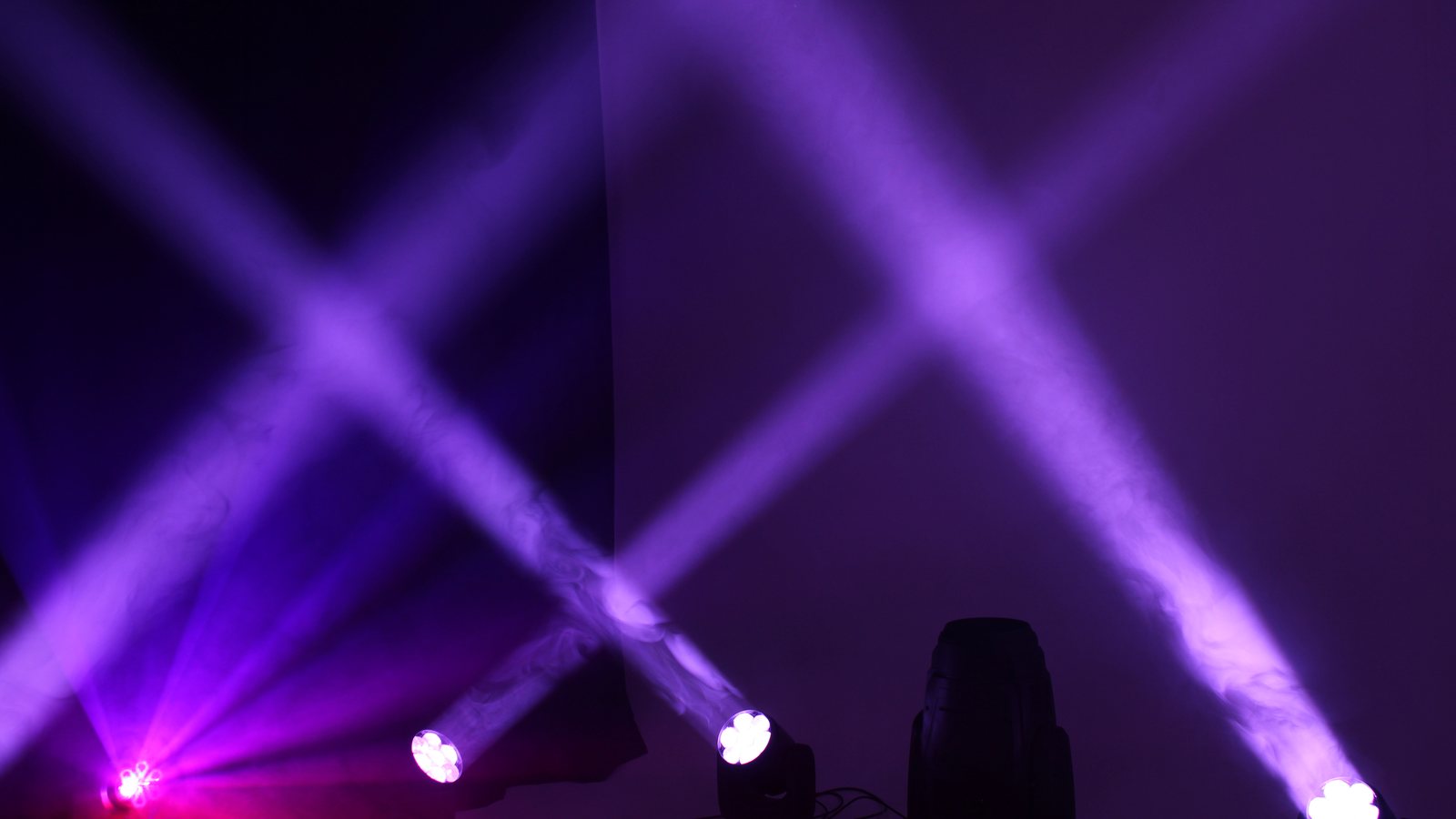 Coloured beams through haze on the blacked-out stage